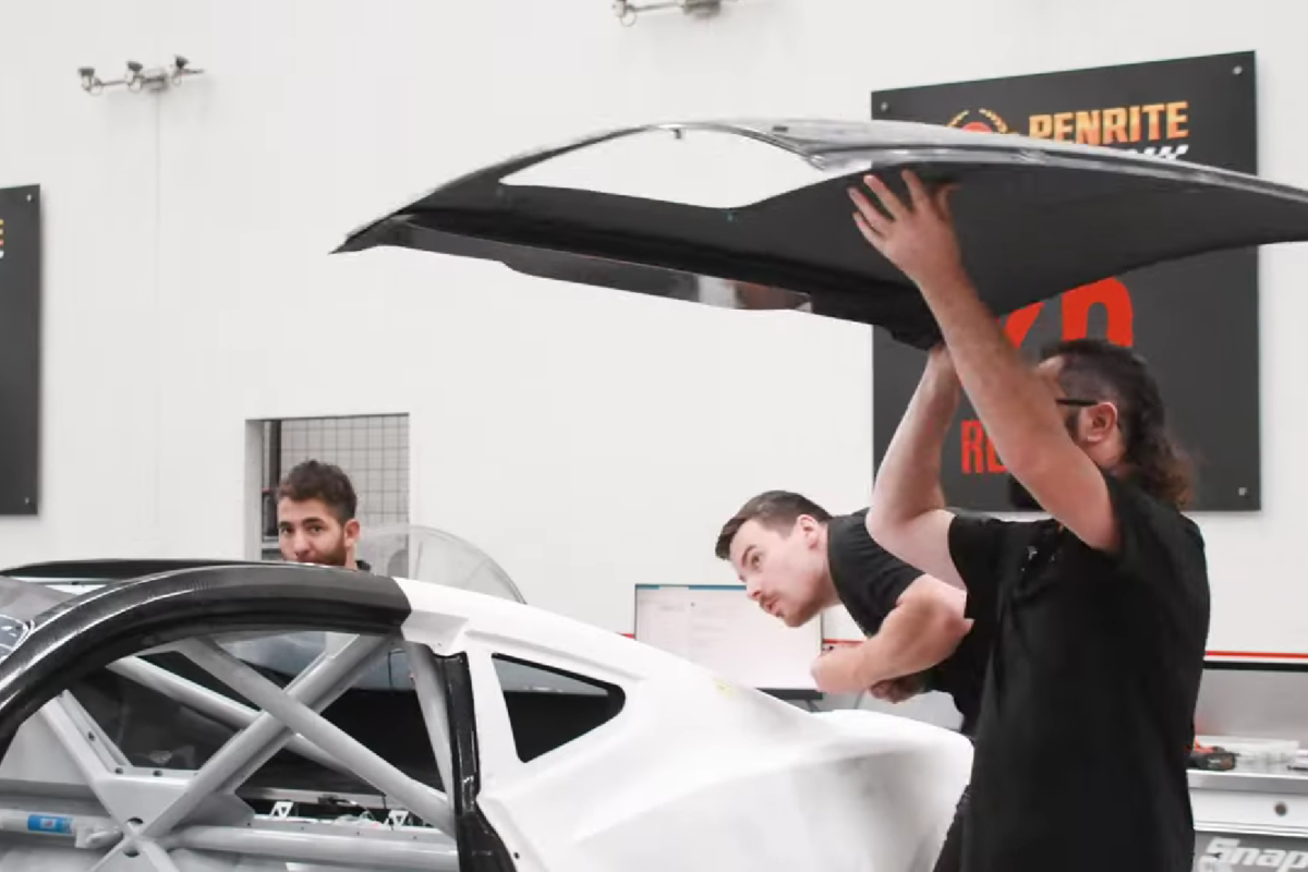 The Grove Racing crew fits the roof panel to one of its Gen3 Ford Mustang Supercars