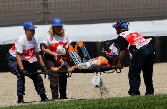 Casey Stoner being stretchered away from the accident scene