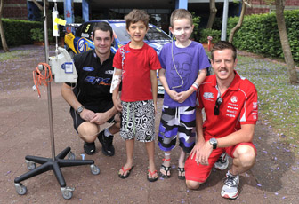 Shane van Gisbergen and James Courtney with two children at Westmead Children