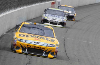 Marcos Ambrose leads Jimmie Johnson