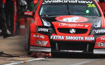 Fabian Coulthard exits pit lane yesterday and runs over a errant GRM wheel gun