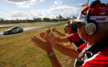 Dick Johnson and former team owner Charlie Schwerkolt clap home James Courtney to one of his two race wins at Queensland Raceway