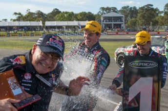 Dane is chased down post-race by the champagne-toting Lowndes and Whincup