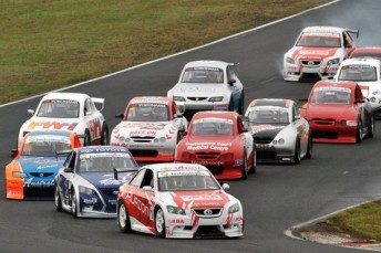 V8 Supercars driver Jack Perkins leads the tight Aussie Racing Cars field through turn two at Eastern Creek
