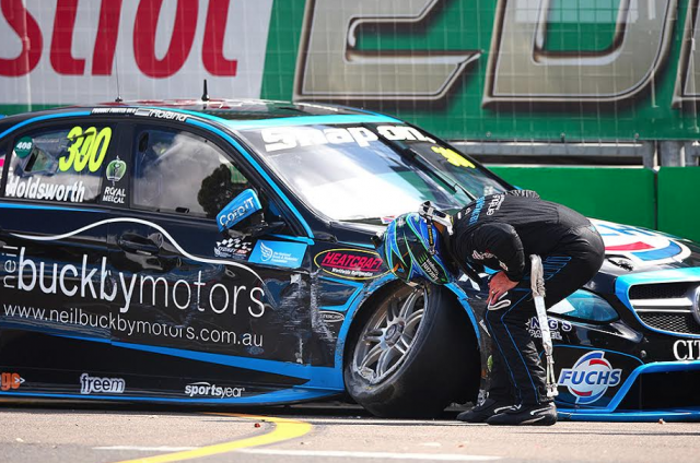 Holdsworth inspects the damage after his crash