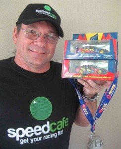 Ian Appelgren with his Speedcafe merchandise and Marcos AMbrose model cars that he collects