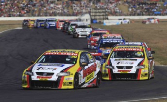 Russell Ingall leads former team-mate Tim Slade at Queensland Raceway last year. Ingall ended the Sprint tyre race with the lap record