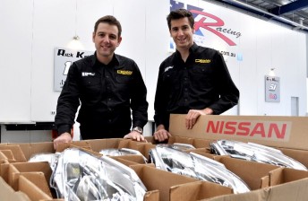 Todd and Rick Kelly with a shipment of Nissan parts recently delivered to Kelly Racing