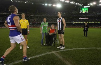 Team captains Matthew Boyd (Western Bulldogs) and Nick Maxwell (Collingwood) toss the coin with Paul and Lucas Dumbrell at Etihad Stadium