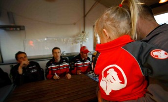 A young Holden fan lines up for an autograph from the HRT drivers