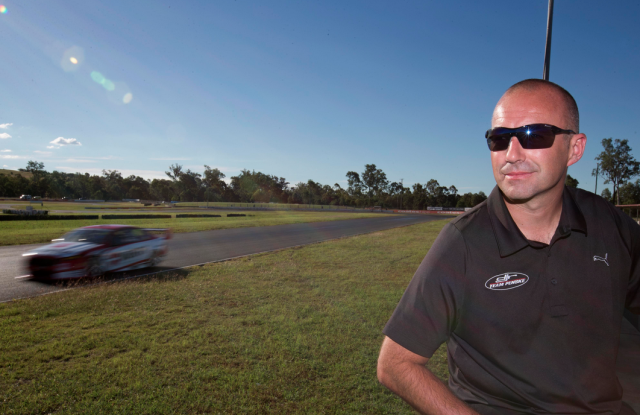 Marcos Ambrose watches on as Scott Pye tests the DJR Team Penske Ford
