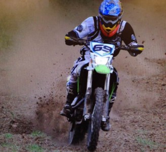 Dale Wood on his motorbike, riding to victory in a recent Endurocross event