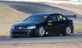 A plain black Kelly Racing Commodore tested at Winton Motor Raceway recently