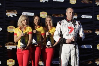 Seven caller Mark Beretta on the podium with the XXXX Angles