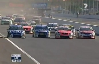 The calm before the storm – the V8 field roar four wide into turn one.