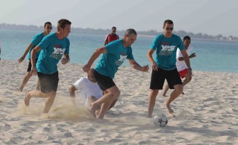 Craig Lowndes steals the ball in the beach soccer match