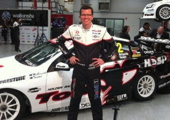 Garth Tander in his retro suit next to his Commodore VE II