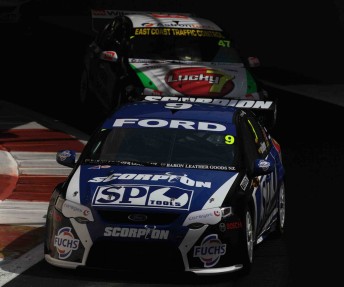 Van Gisbergen leads Tim Slade through the pit lane tunnel