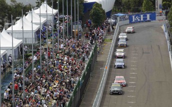 The V8 pack races in front of the Sydney Telstra 500 crowd