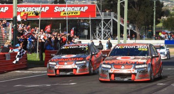 Craig Lowndes leads Jamie Whincup across the Bathurst finish line for their famous one-two result
