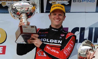 Garth Tander proudly holds aloft his Race 6 trophy at the Clipsal 500