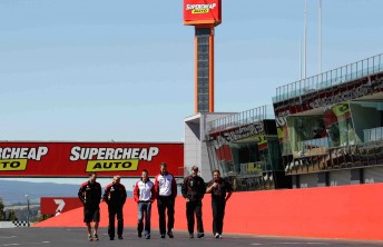 Russell Ingall, James Courtney and Mark Skfie, along with their engineers, walk down Pit Straight at Mount Panorama – home of the Supercheap Auto Bathurst 1000