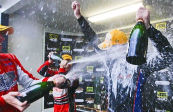 thumb Garth Tander and Lee Holdsworth give Shane van Gisbergen a champagne soaking on the Hamilton podium