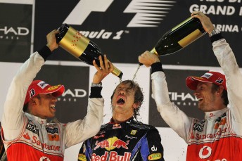 Sebastien Vettel celebrates his 2010 championship victory with 2009 champion Jenson Button (right) and 2008 champion Lewis Hamilton (left)