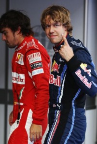 Sebastian Vettel celebrates his pole position alongside third placed starter Fernando Alonso