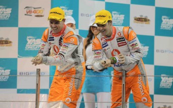 Craig Lowndes and Jamie Whincup celebrate on the Yas Marina Circuit podium