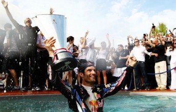 Mark Webber celebrates in the pool at Monaco