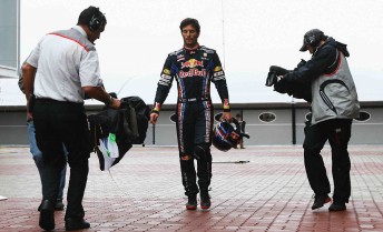 Mark Webber walks back to the Red Bull pit garages after his accident in Korea