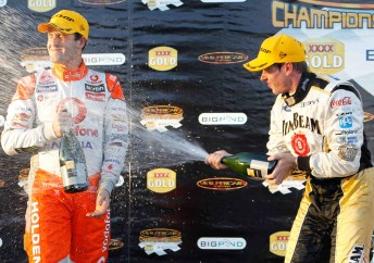 Jamie Whincup cops the champagne spray from Winton winner James Courtney