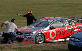 Officials dig deep to get Jamie Whincup out of the sand trap at Winton Motor Raceway yesterday