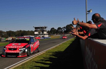 Jamie Whincup leads Craig Lowndes across the line to win yesterday