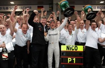Nico Rosberg and Ross Brawn (front) celebrate with the Mercedes crew