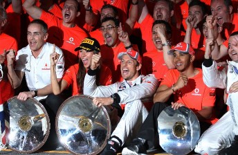 Jenson Button and Lewis Hamilton celebrate with the McLaren team