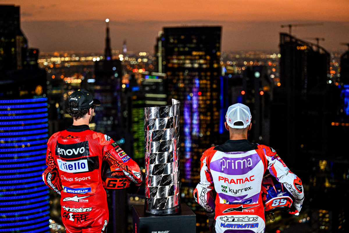 Francesco Bagnaia (left of frame) and Jorge Martin (right) with the MotoGP championship trophy in Doha, ahead of this weekend's Qatar Grand Prix. Image: Supplied