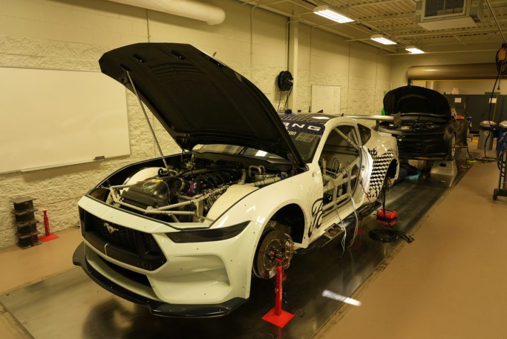 A Ford Mustang and Chevrolet Camaro Gen3 race car being prepared for the initial Supercars wind tunnel test at Windshear in the United States. Image: Supplied