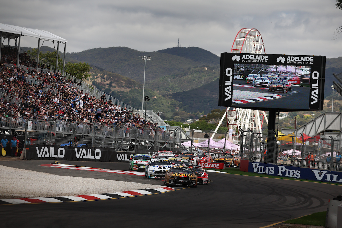 The crowd watches on as the Supercars field races through Senna Chicane at the Adelaide Parklands Circuit in Race 28 of the 2023 season at the Adelaide 500