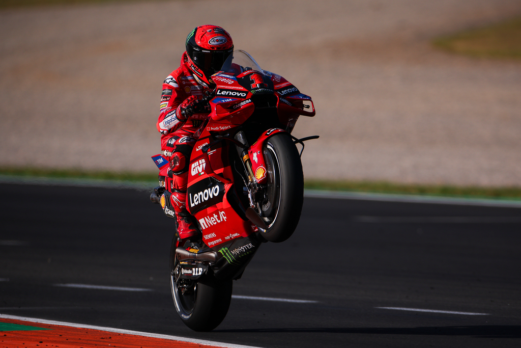 2023 champion Francesco Bagnaia performs a wheelie on his Ducati Team MotoGP bike