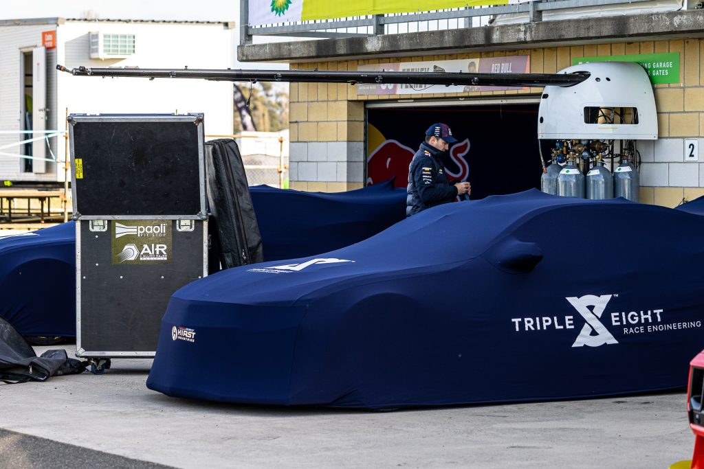 Triple Eight Camaro Supercars under car covers in pit lane