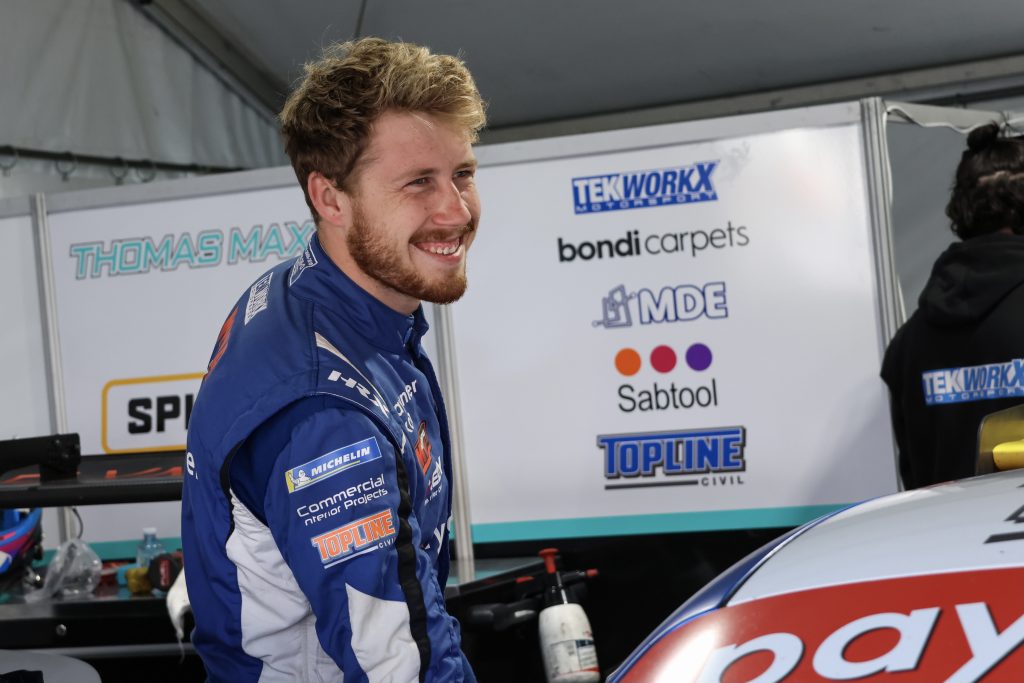 Max Vidau stands in the Carrera Cup paddock